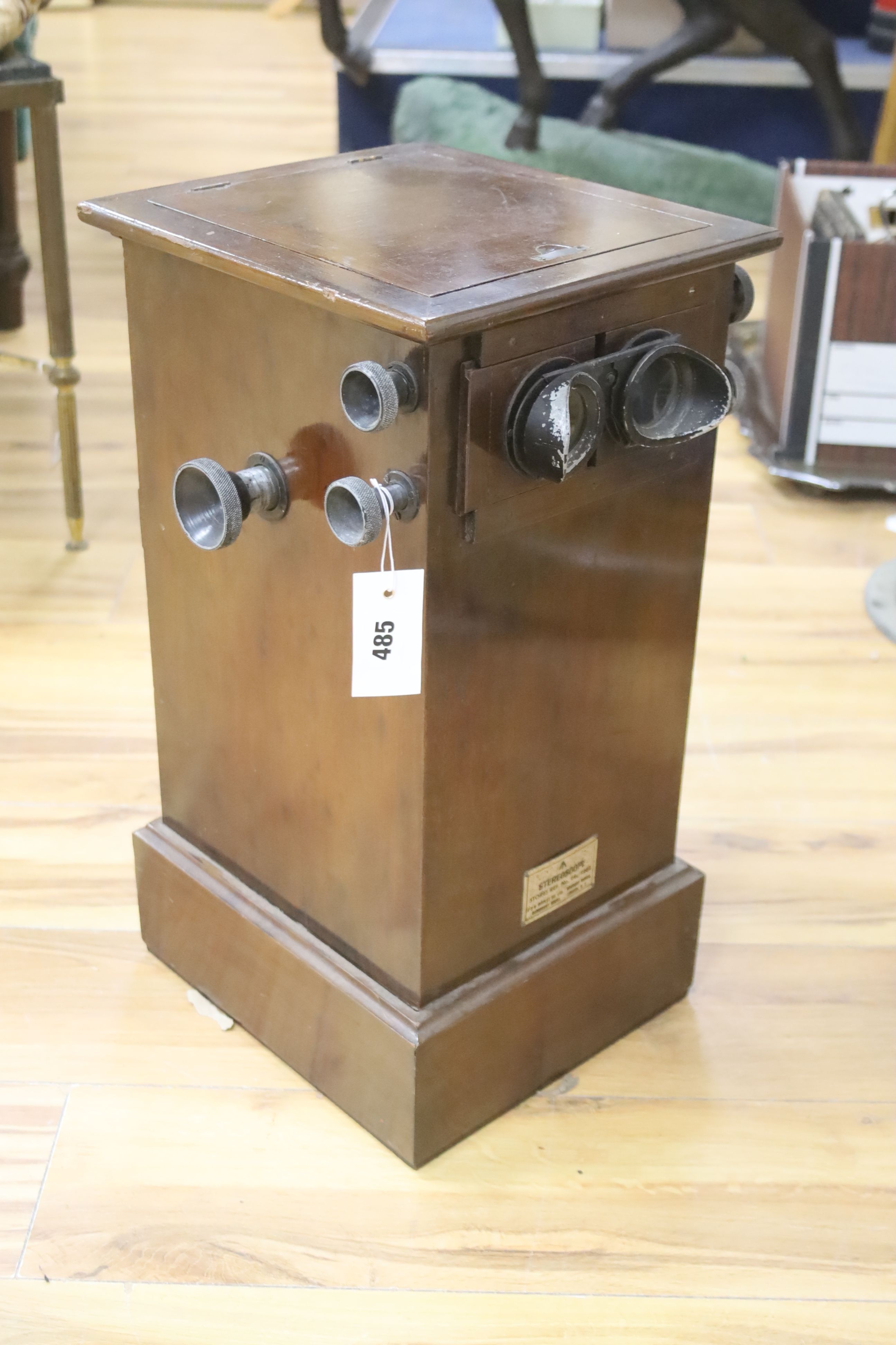 An early 20th century mahogany table top stereoscopic card viewer with monochrome Boer War cards, height 53cm